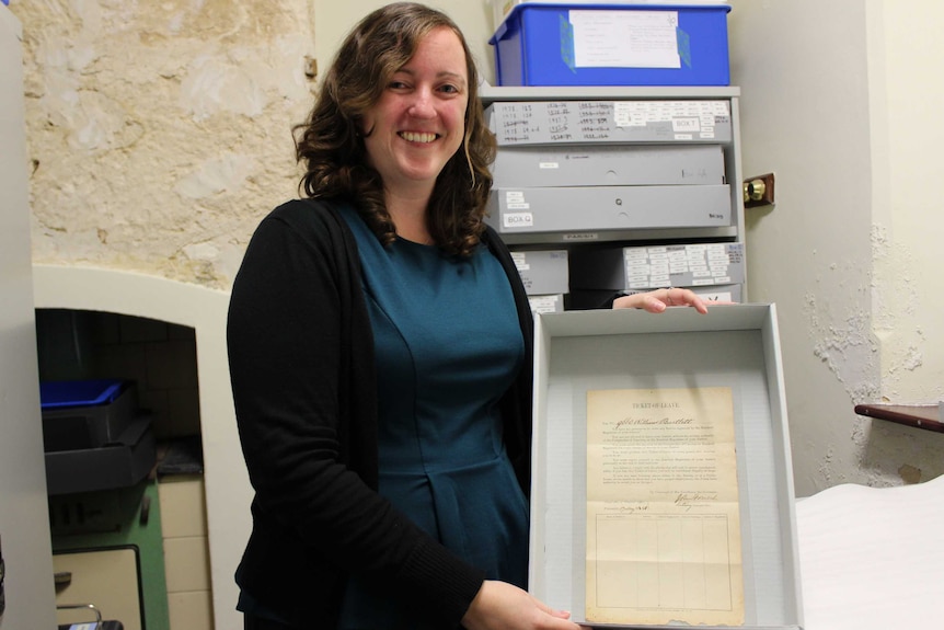 Fremantle Prison assistant curator Eleanor Lambert displays the ticket-of-leave issued to William Bartlett in 1881.