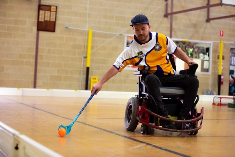 An action shot of Jack O'Keeffe playing powerchair hockey