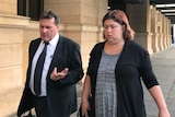 A man and a woman walking outside an Adelaide court.