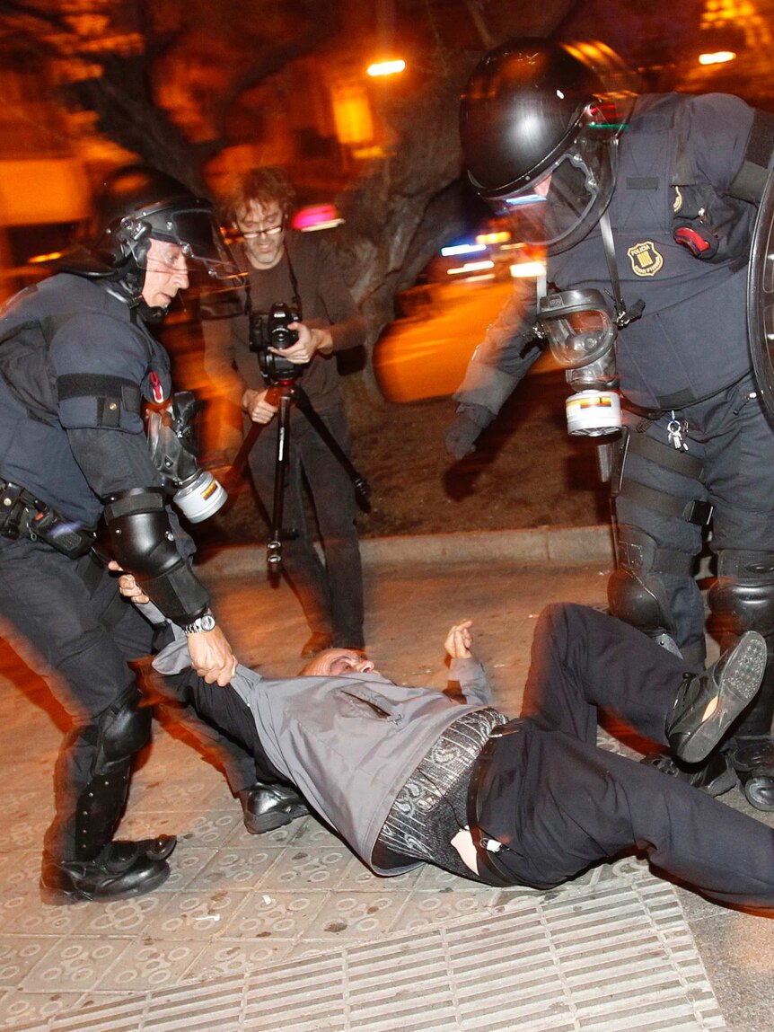 Police scuffle with protester in Spain