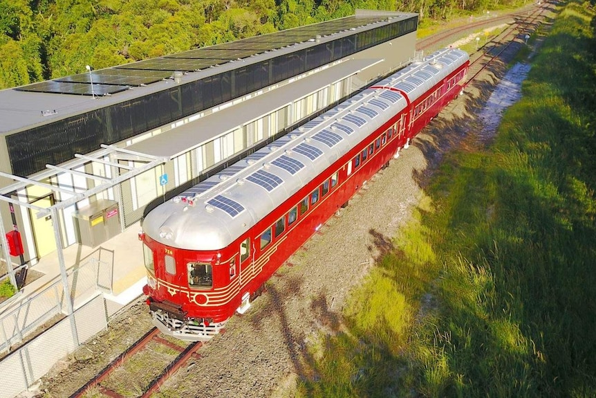 Aerial shot of a train in Byron Bay with solar panels on its roof.