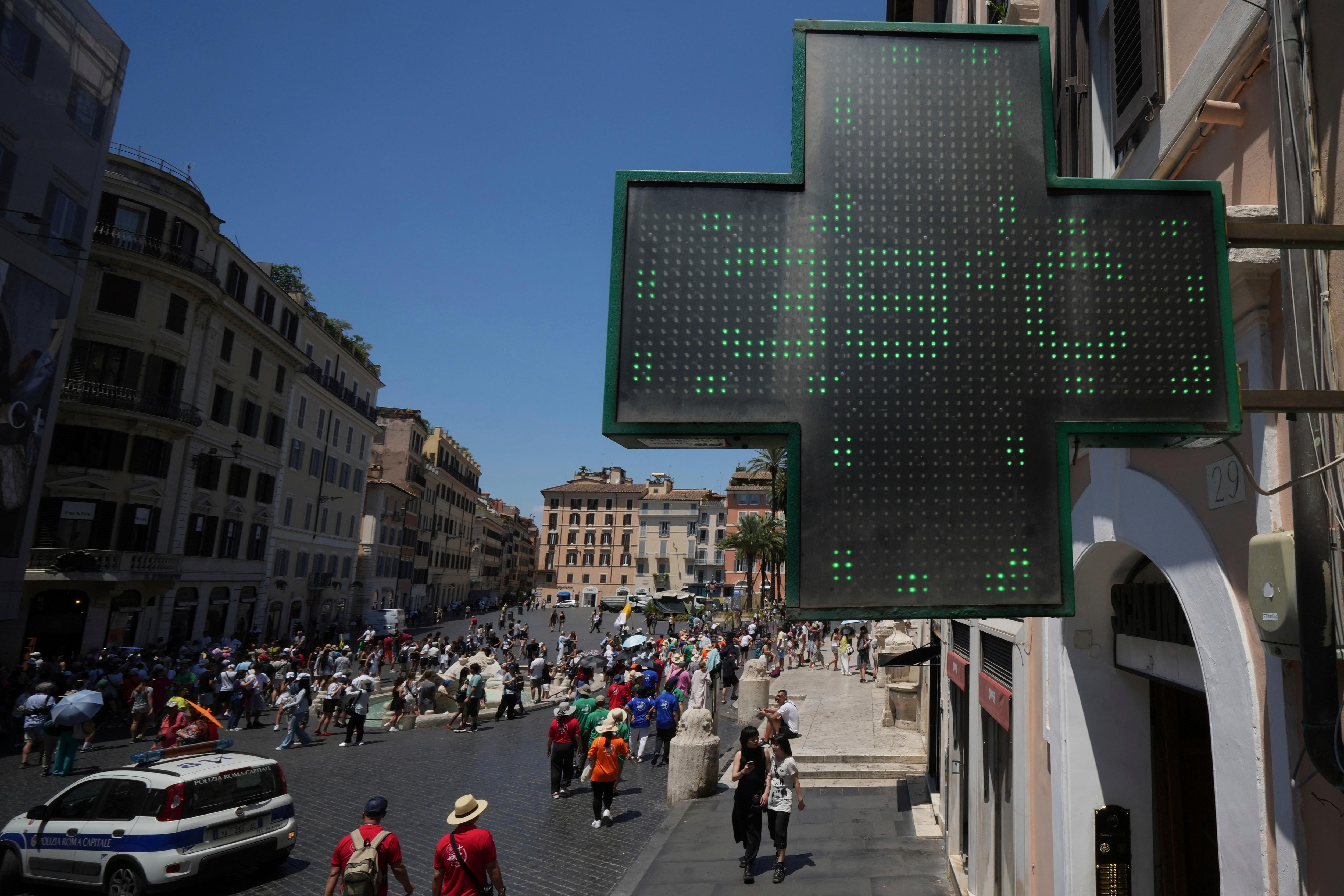The thermometer of a drugstore shows the temperature of 39 degrees Celsius during a heat wave, in Rome