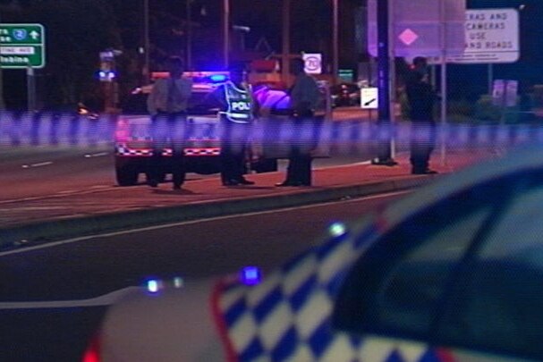TV still of police at the scene of road rage shooting murder at Burleigh Heads on the Gold Coast.
