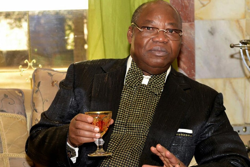 Nigerian ex-oil minister Dan Etete drinking a beverage.