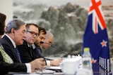 New Zealand foreign minister Winston Peters sits with colleagues in delegation table in Beijing.