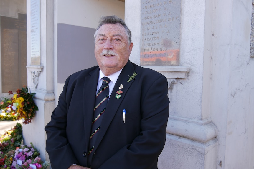 A man in a suit at an Anzac Day event