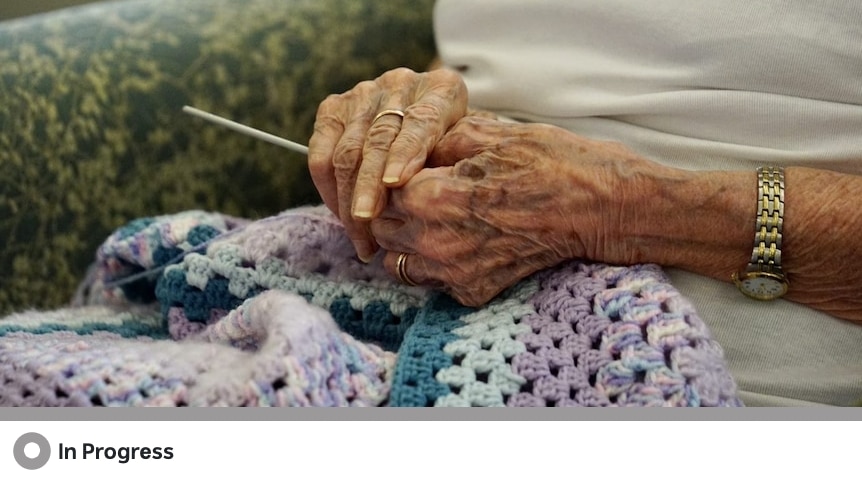 An elderly woman's hands knitting