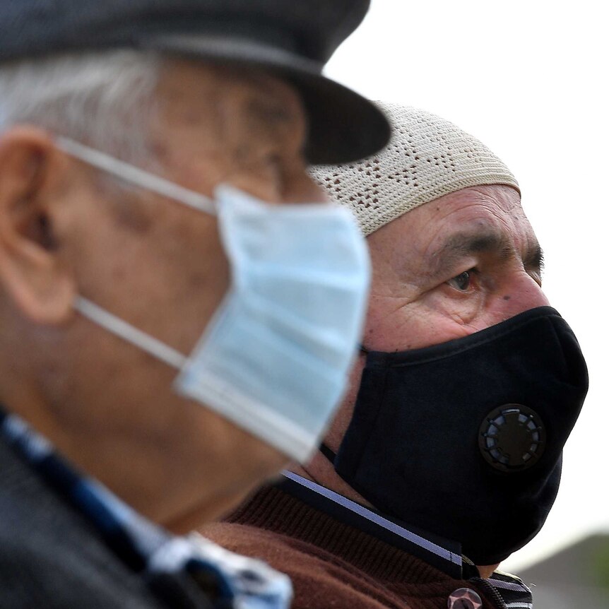 Muslim worshippers wearing face masks wait to enter the Mosque for Friday prayer.