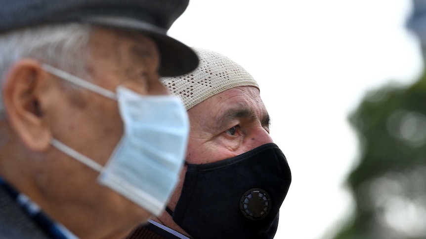 Muslim worshippers wearing face masks wait to enter the Mosque for Friday prayer.