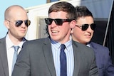 Toowoomba horse trainer Ben Currie flanked by two friends