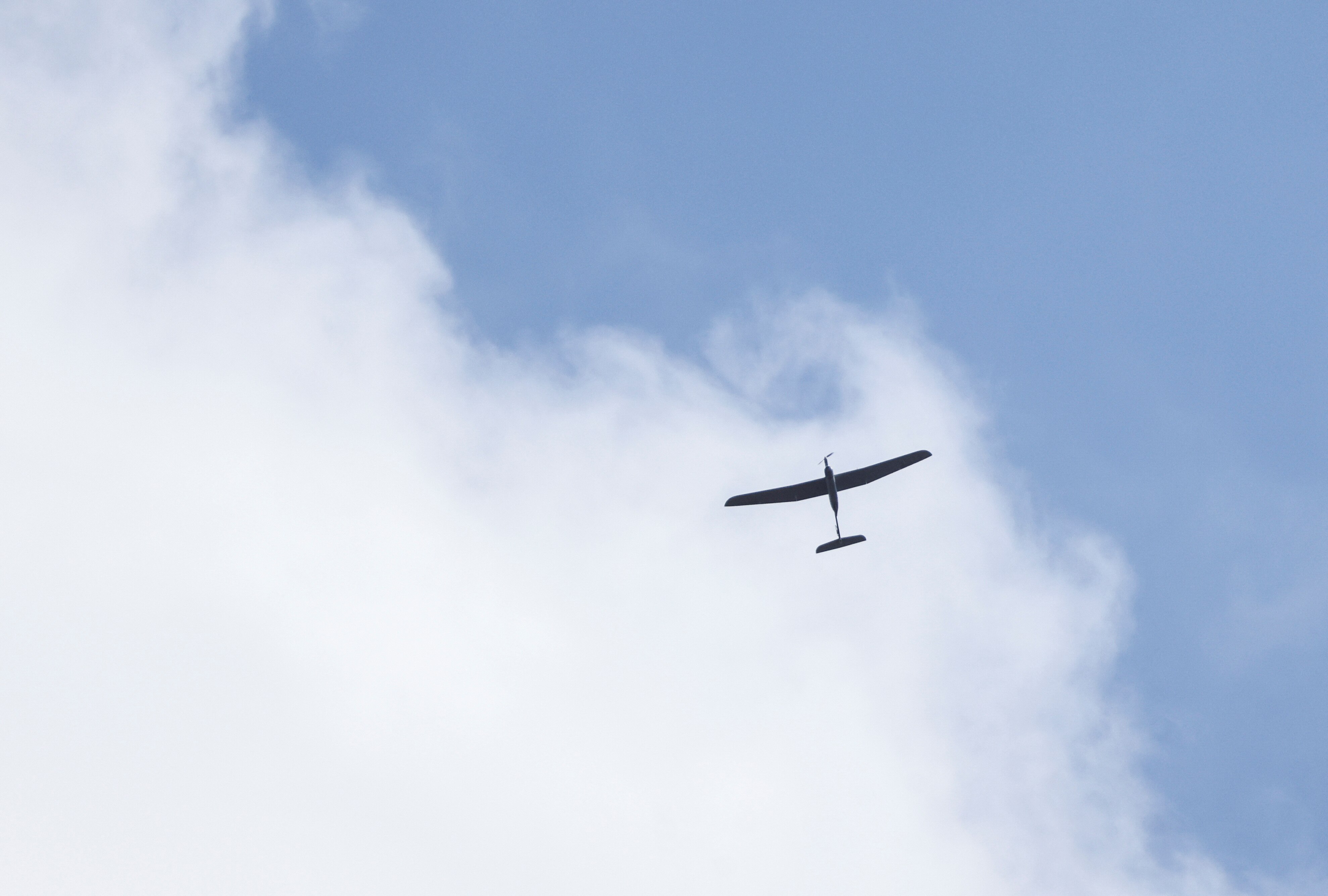 A small drone flies through a cloud