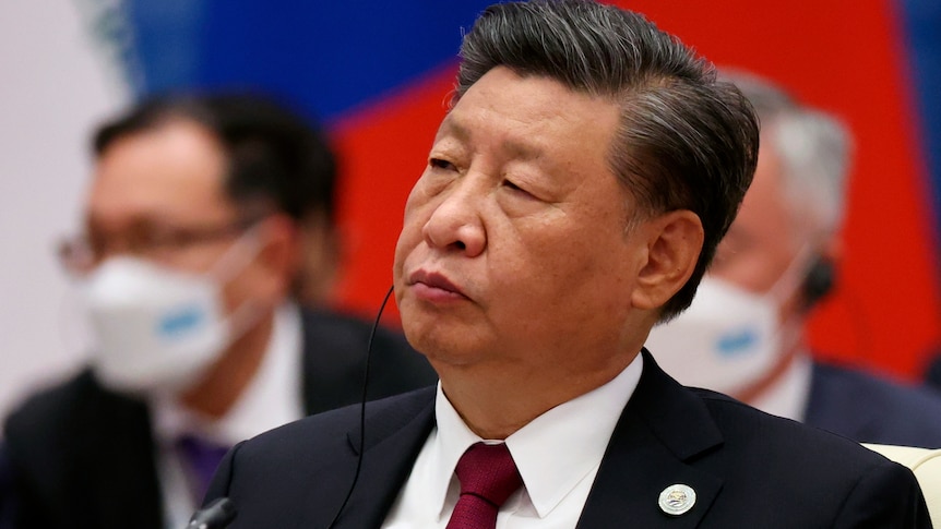 A man with an ear piece in listens at a conference