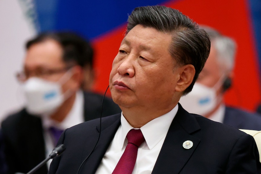 A man with an ear piece in listens at a conference