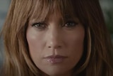 A close up of Jennifer Lopez's face looking determined.
