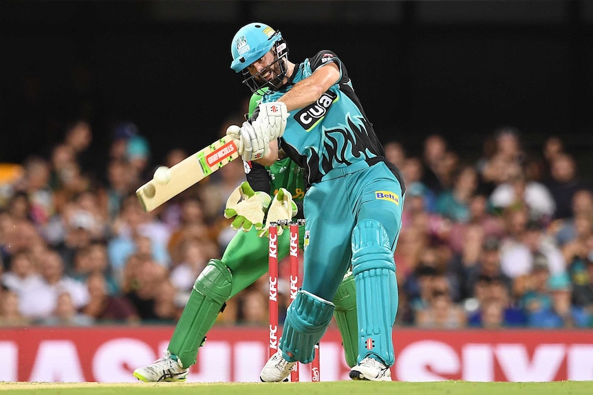 Batsman hits a six, as the shadow of the ball can be seen on the bat.