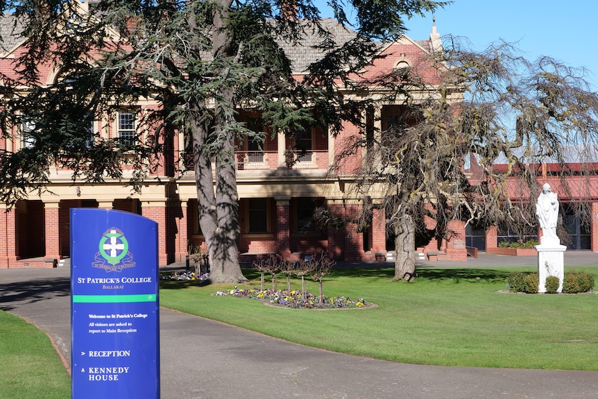 A school building with a sign in front of the building reading St Patricks College