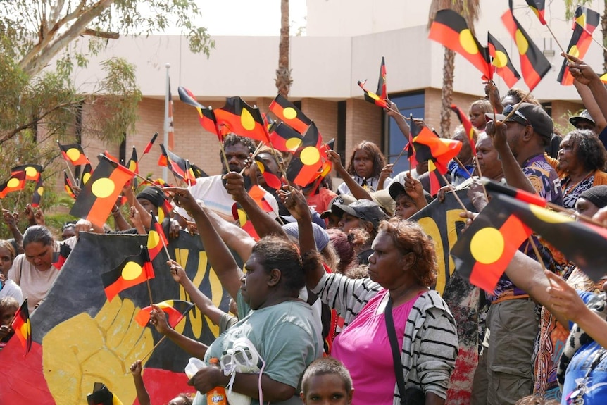 Supporters of Kumanjayi Walker gather outside the Alice Springs Local Court as a decision to send the case to trial comes down.