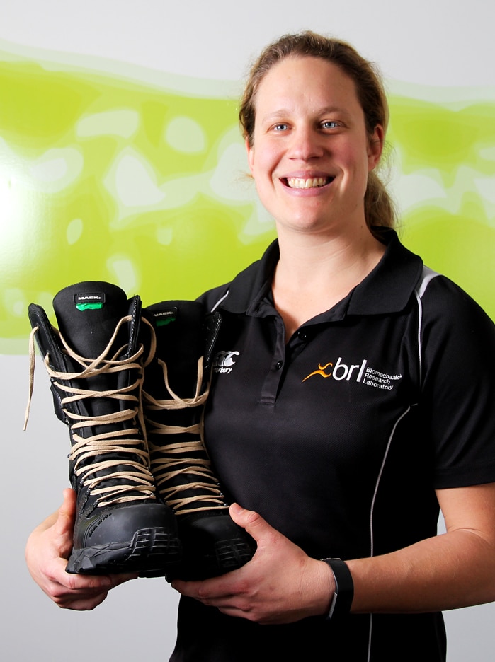 UOW PhD candidate Jess Dobson holds her new design of mining boots.