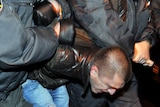 Russian riot police detain an opposition activist during an unauthorised rally in Saint-Petersburg.