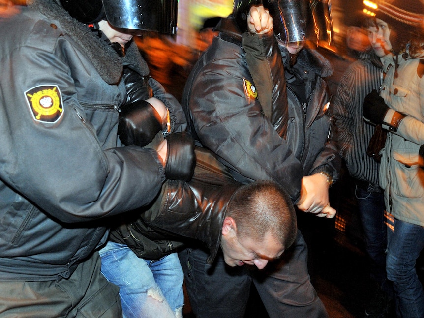 Russian riot police detain an opposition activist during an unauthorised rally in Saint-Petersburg.