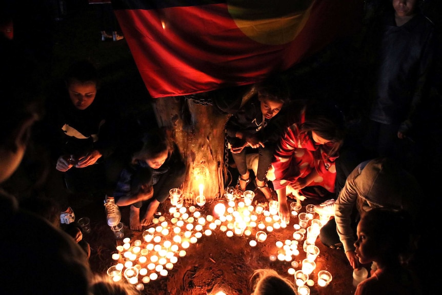 Children at a candlelight vigil.