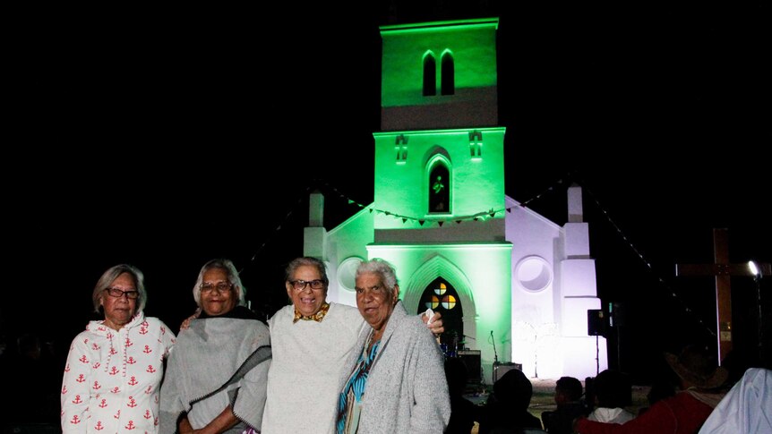 Sisters (from left) Celine Howard, Leonie Kelly, Pauline Murphy, and Tracey Howard, in front of the Beagle Bay church at night