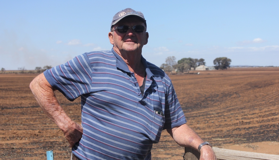 Farmer Bruce Buckby leans against a fence