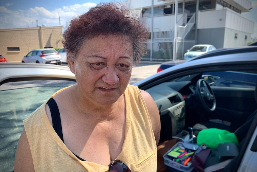 Logan grandmother Maurie McCluthie, 61, stands beside her car, south of Brisbane.