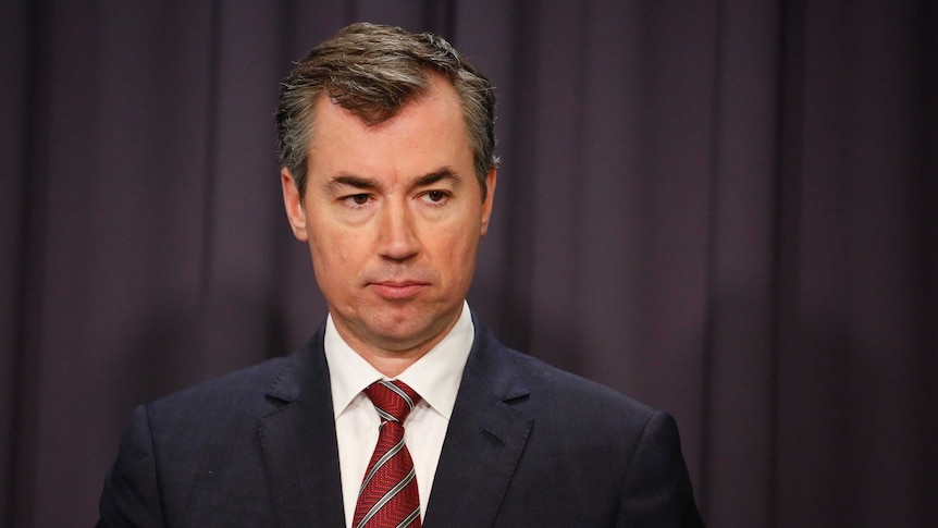 Liberal Justice Minister Michael Keenan addresses the media