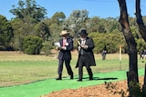 Two men walk through Rookwood cemetery in Sydney.
