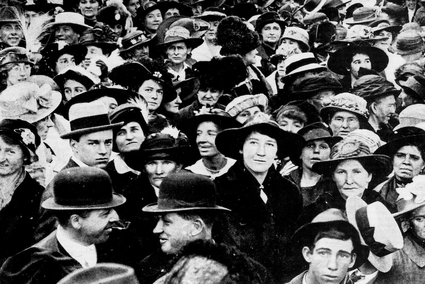 Black and white photo of a crowd of women standing outside NSW Parliament in 1917