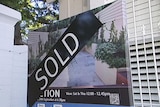 A sold sign erected outside a house