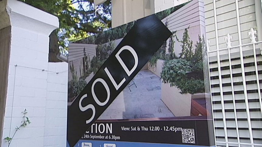 A sold sign erected outside a house.