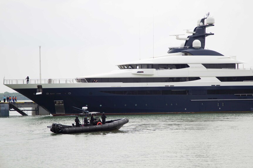 Malaysia's marine police on their security boat watch luxury yacht Equanimity
