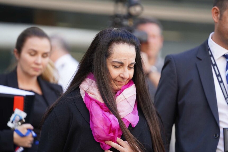 Carmel Barbagallo leaves court looking down with a slight smile on her face.
