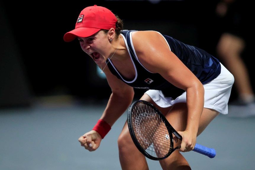 Ash Barty lets out a joyous roar after winning the WTA Finals decider against Elina Svitolina.