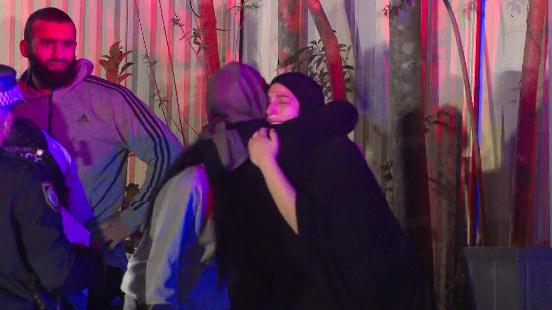 two women hugging and crying