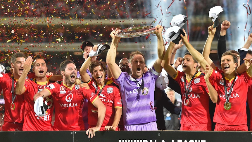 Adelaide United players celebrate after the A-League grand final against Western Sydney Wanderers.