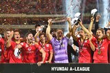 Adelaide United players celebrate after the A-League grand final against Western Sydney Wanderers.