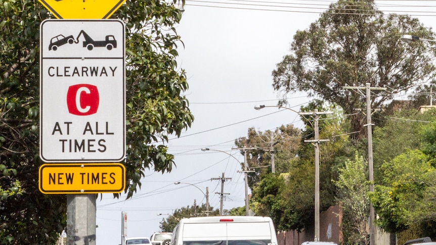 Traffic passes sign reading 'clearway at all times'.