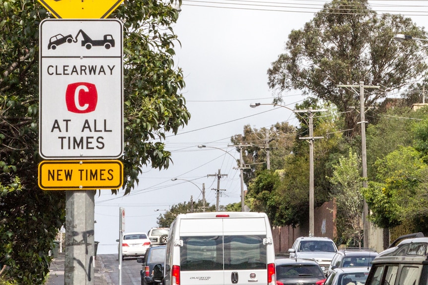 Traffic passes sign reading 'clearway at all times'.