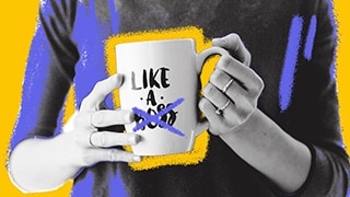A person holding a 'Like a boss' mug with 'boss' crossed out with purple and yellow design around