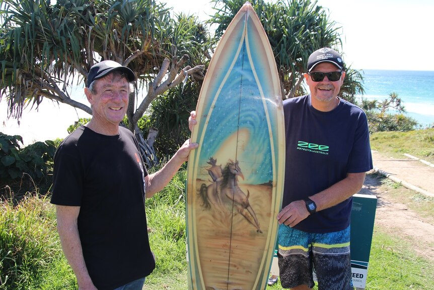 Bill Gibson (left) and Peter Gilson with the stolen surfboard