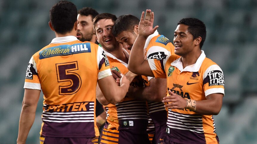 Brisbane's Ben Hunt (C) is congratulated by the Broncos after his try against South Sydney.