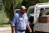 Man walking out of car during the day.