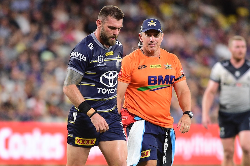 A North Queensland NRL players walks off the field after being injured.