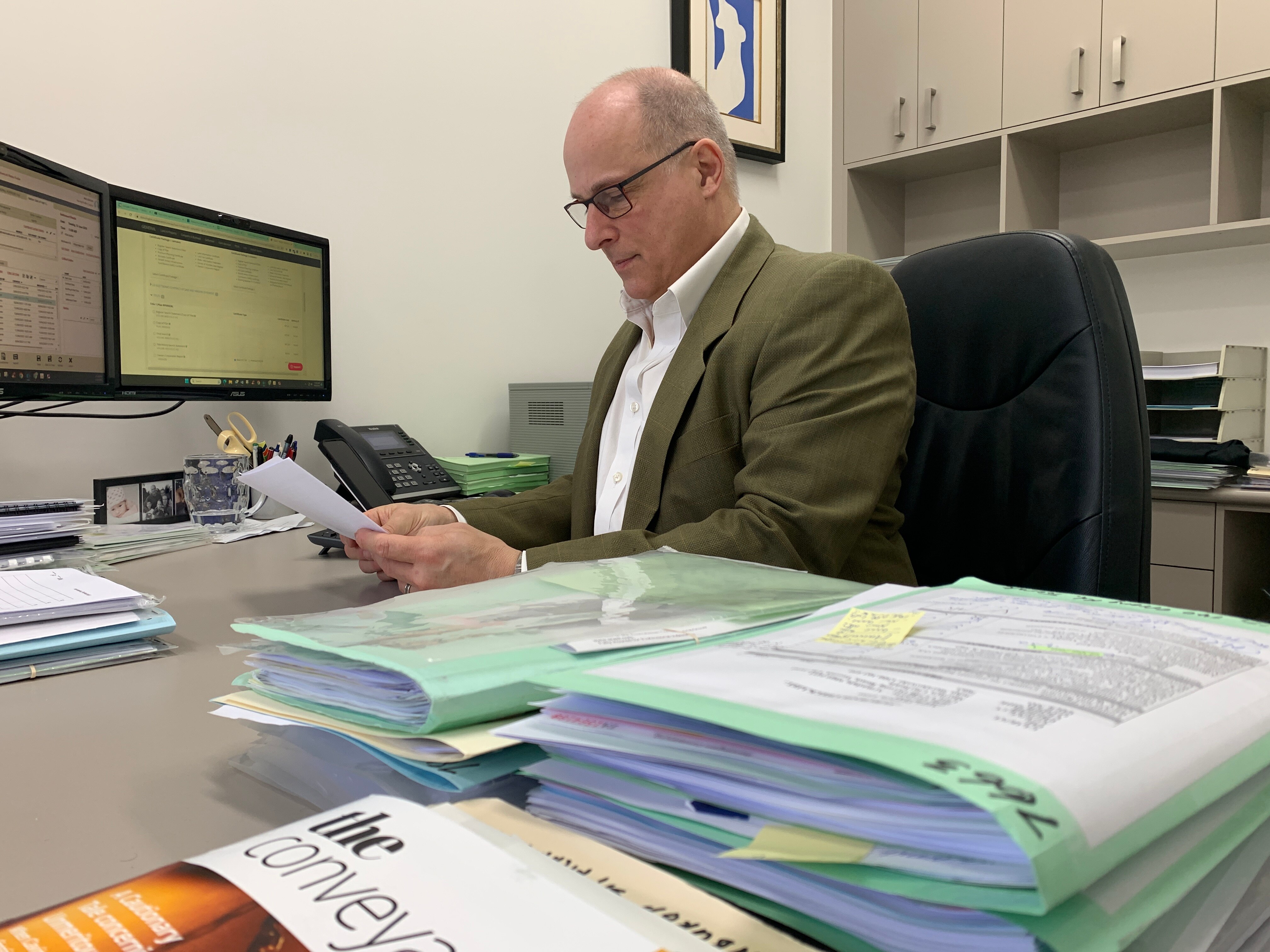 Paul Garson looking at papers in his office.