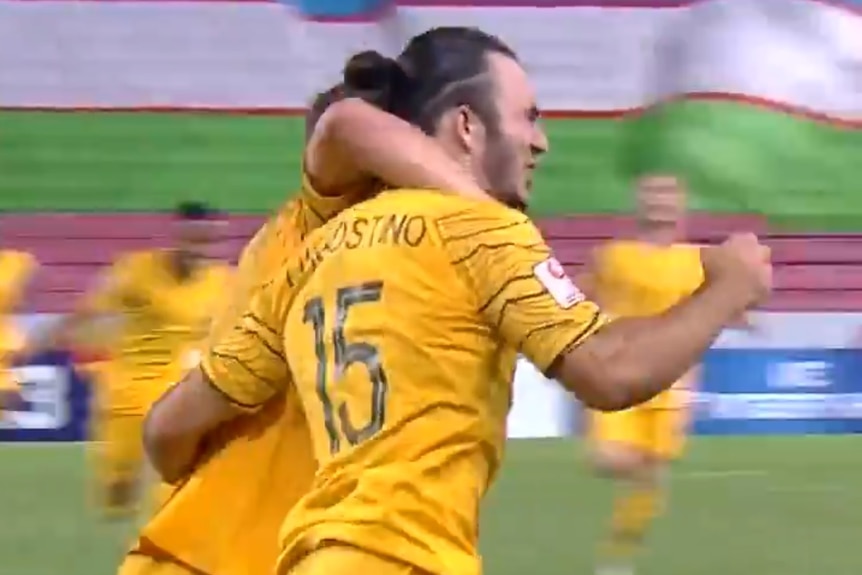 Nicholas D'Agostino pumps his fist as a teammate puts an arm around him in celebration