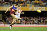 Brisbane Lions defender Justin Clarke kicks the ball against Sydney at the Gabba