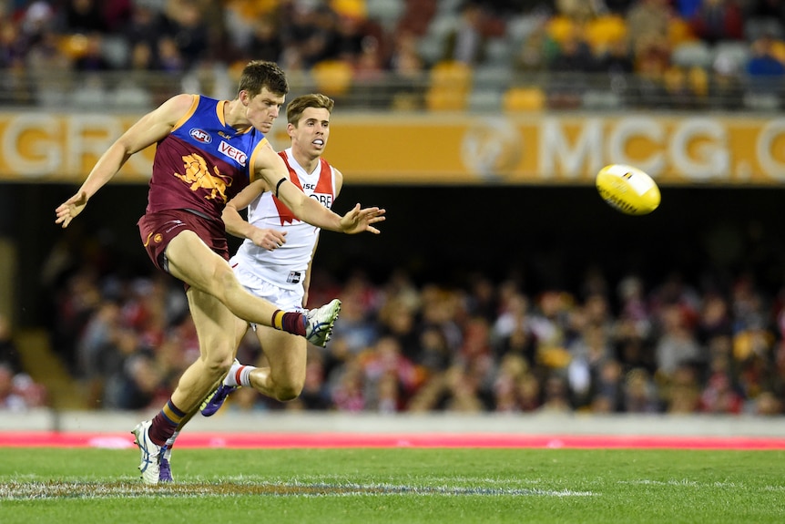 Brisbane Lions defender Justin Clarke kicks the ball against Sydney at the Gabba